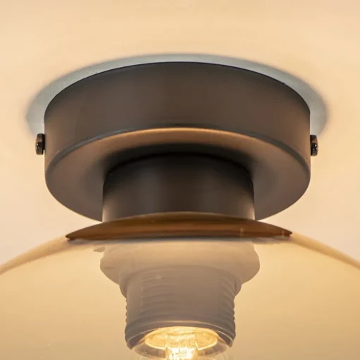 Mat zwarte plafondlamp met amber glazen bol