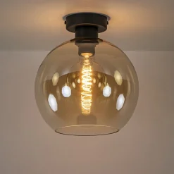 Mat zwarte plafondlamp met amber glazen bol